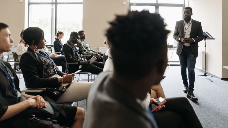 Facilitator delivering a training session to a seated group